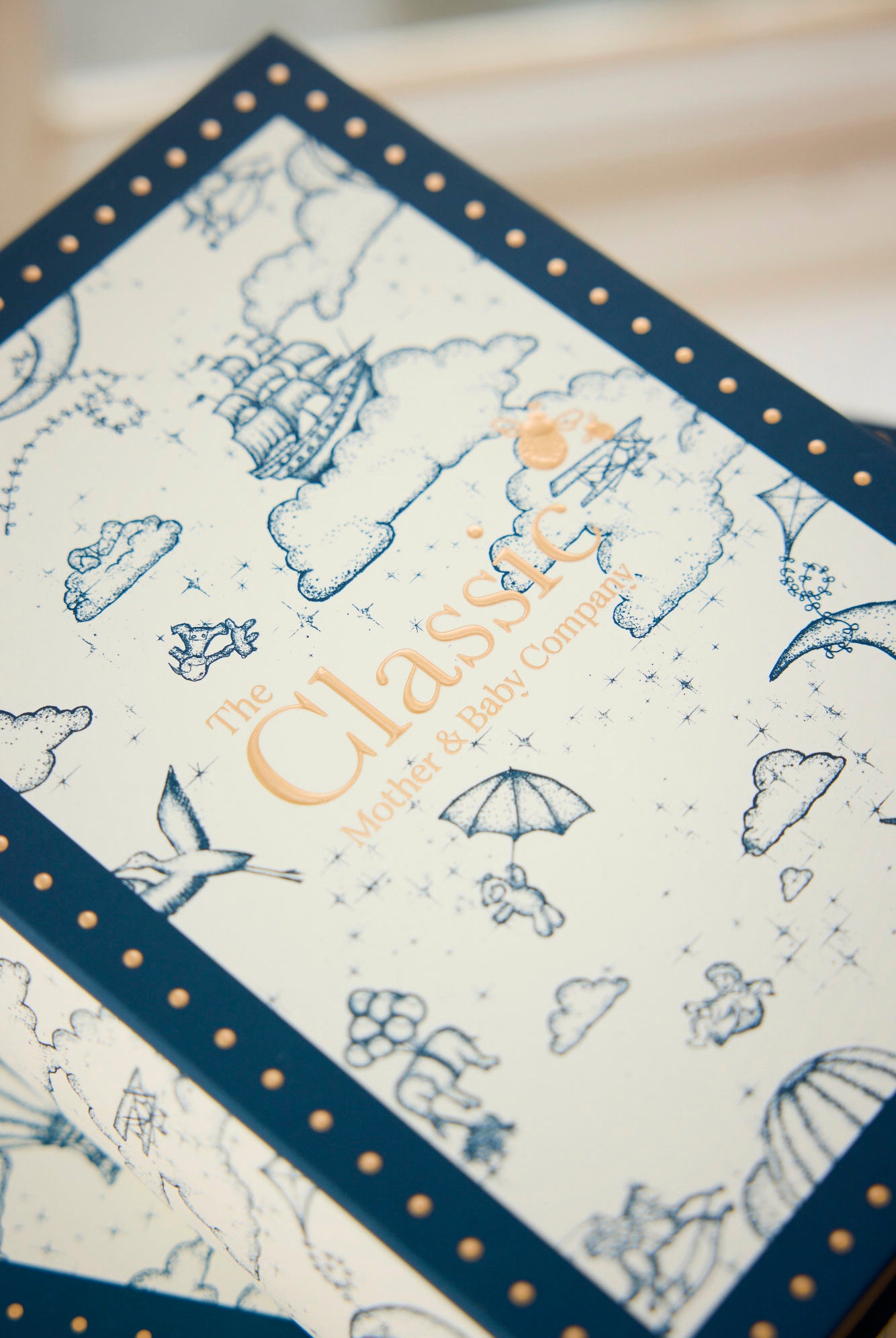 Patterned product with 'The Classic Baby Company' branding on a light background