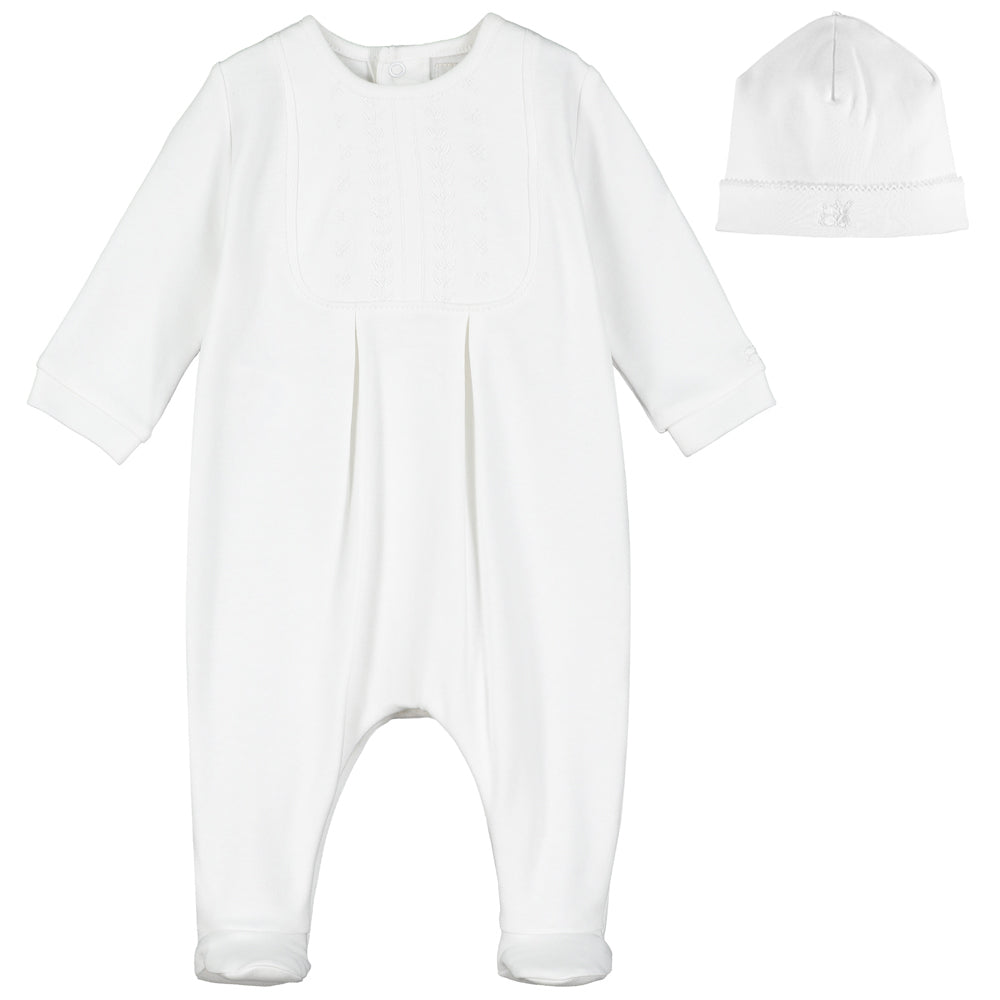 White baby onesie with matching hat on a white background