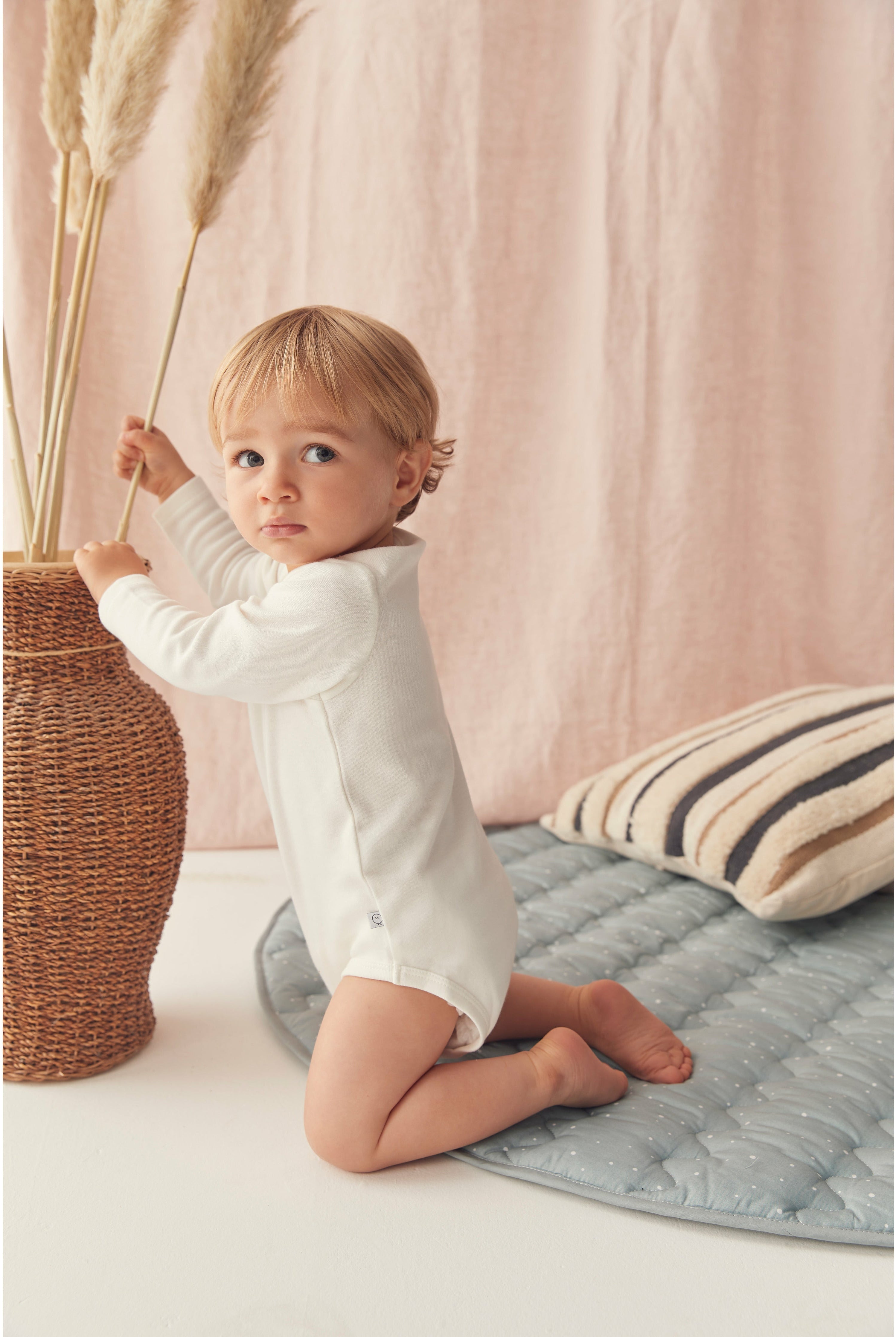 Baby in white bodysuit - Hospital Bag Esseentials