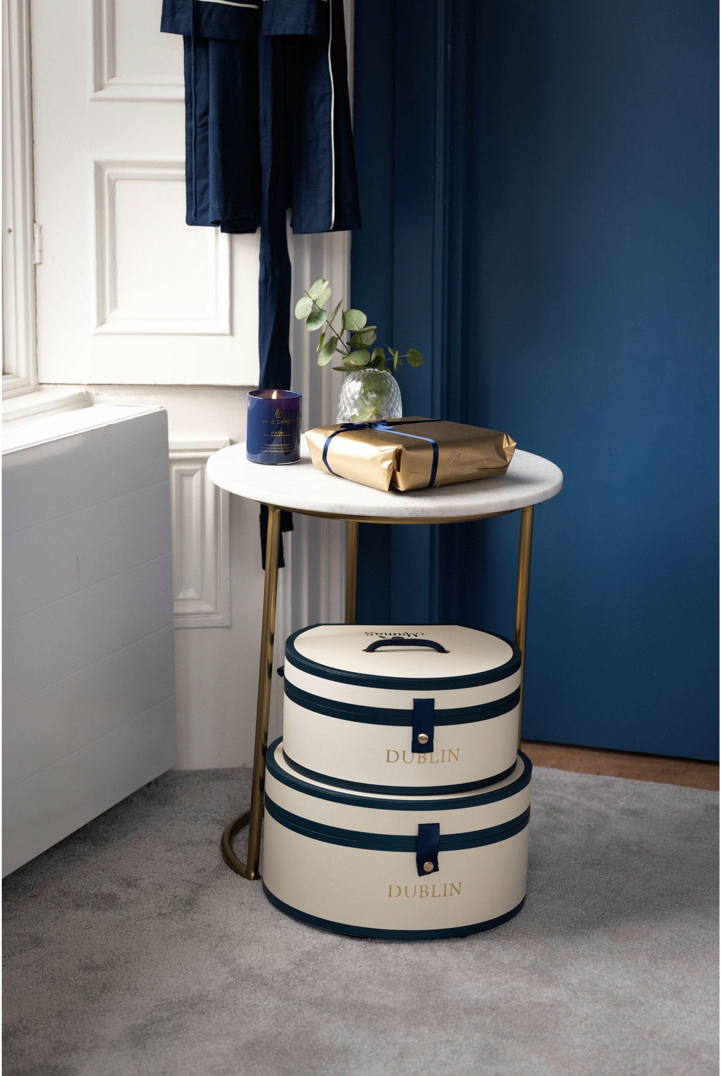 Hat boxes stacked in bedroom with navy dressing gown- Mamas Hospital Bag Baby Gift Dublin Ireland