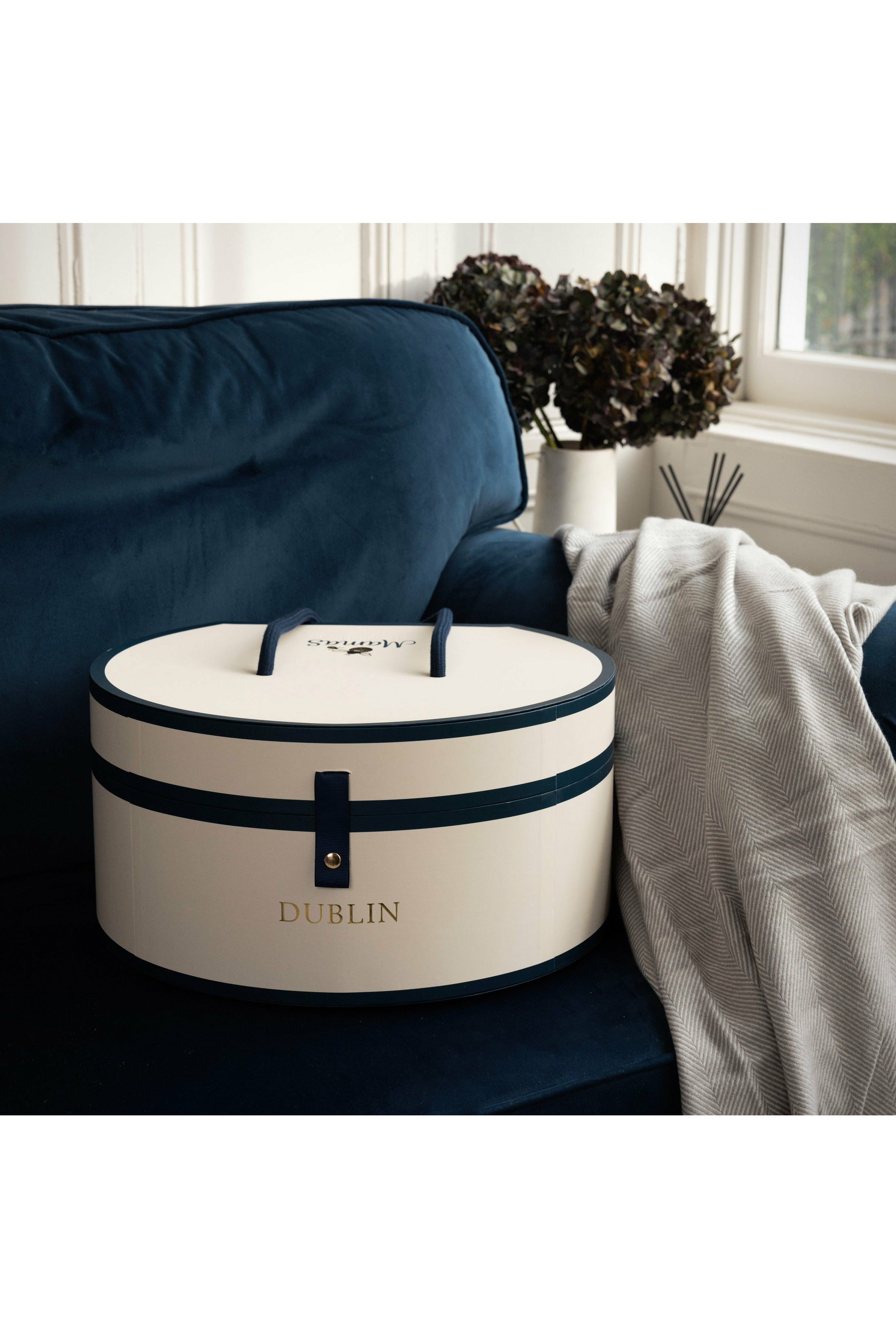 Hat box on navy sofa