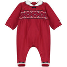 Red baby romper with white collar and black trim on a white background