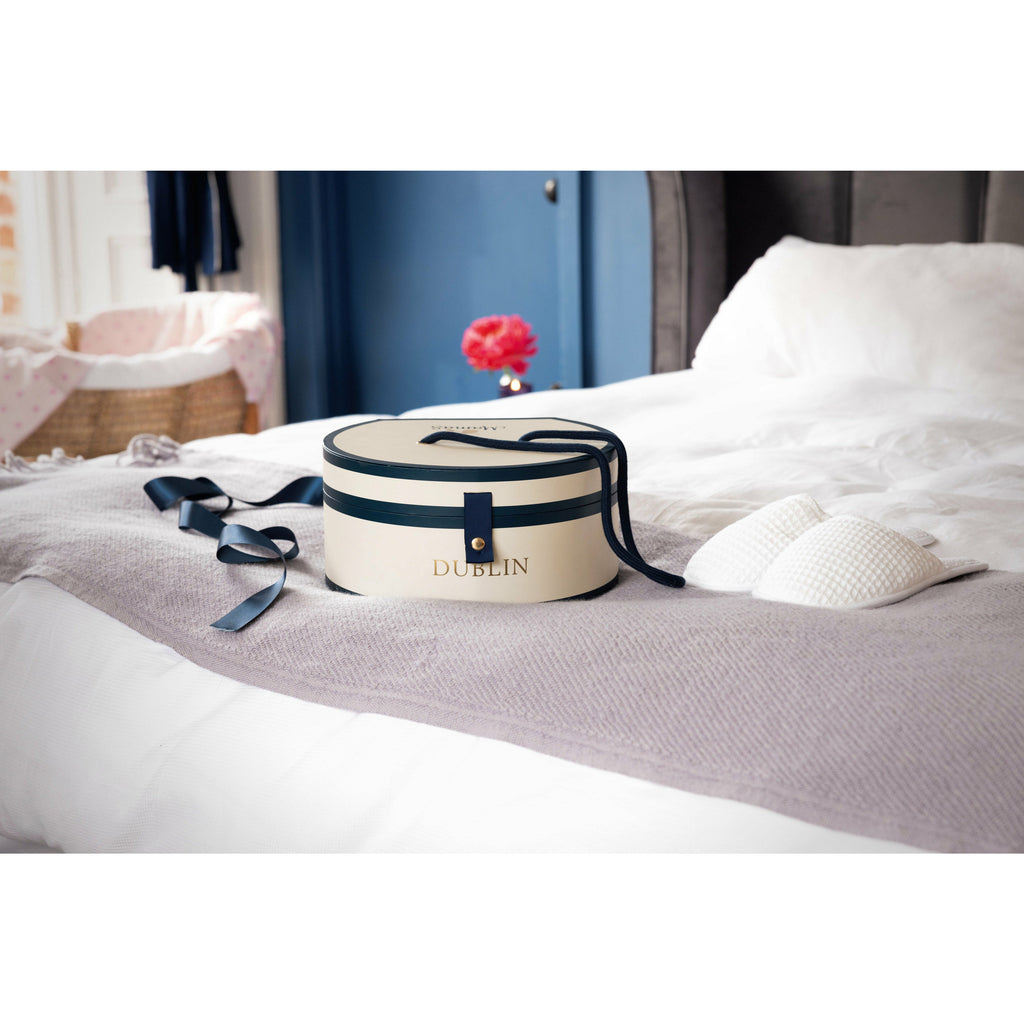 Dublin Hat Box on bed with white slippers- Mamas Hospital Bag