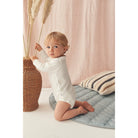 Baby in white bodysuit - Hospital Bag Esseentials