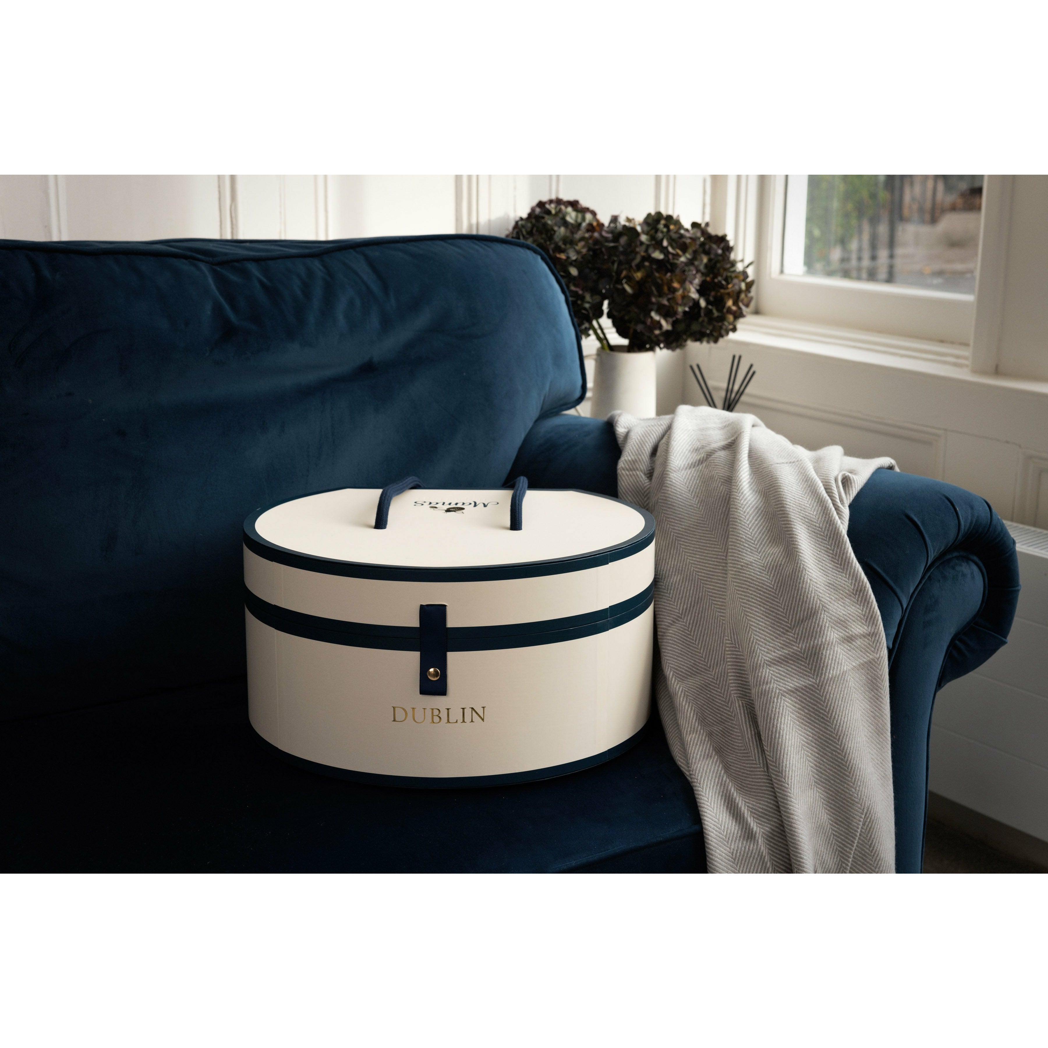 Hat box on navy sofa